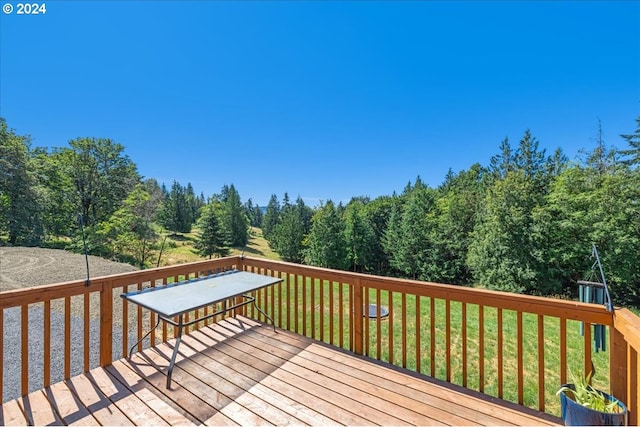 wooden deck with a lawn