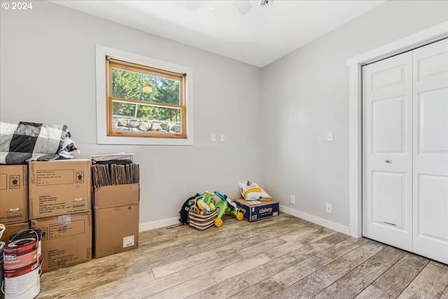 playroom with light wood-type flooring and ceiling fan