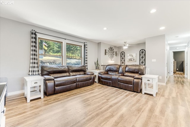 living room featuring light wood-type flooring and ceiling fan