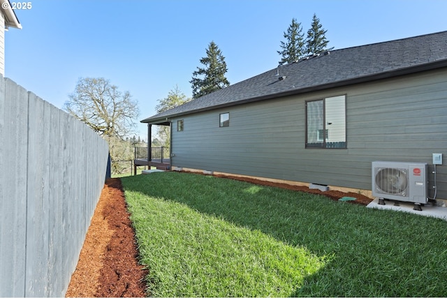 view of yard featuring fence and ac unit