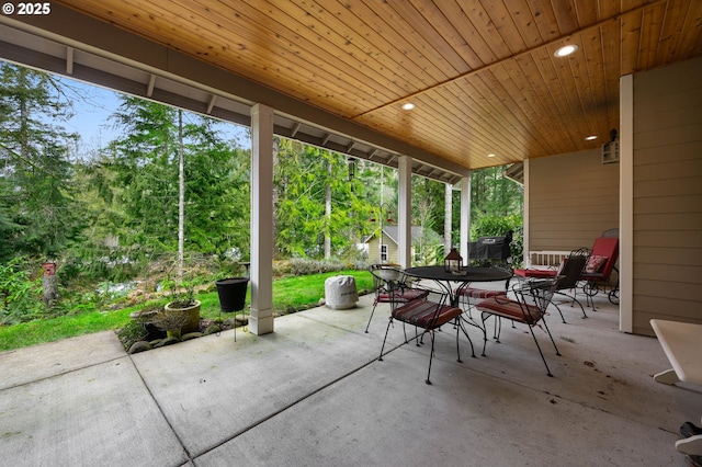23275 E Wind Tree Loop, Rhododendron, OR 97049 - view of patio featuring outdoor dining area, view of scattered trees, and an outdoor structure