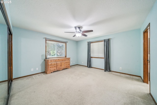 17476 SW Edy Rd, Sherwood, OR 97140 - unfurnished bedroom featuring light colored carpet, baseboards, a textured ceiling, and a ceiling fan