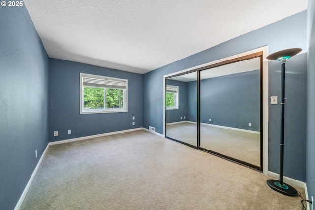 17476 SW Edy Rd, Sherwood, OR 97140 - unfurnished bedroom featuring carpet, baseboards, a closet, and a textured ceiling