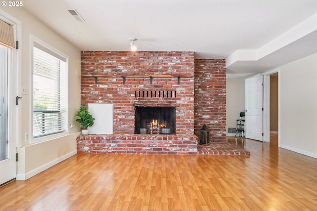 17476 SW Edy Rd, Sherwood, OR 97140 - unfurnished living room with wood finished floors, a brick fireplace, and baseboards