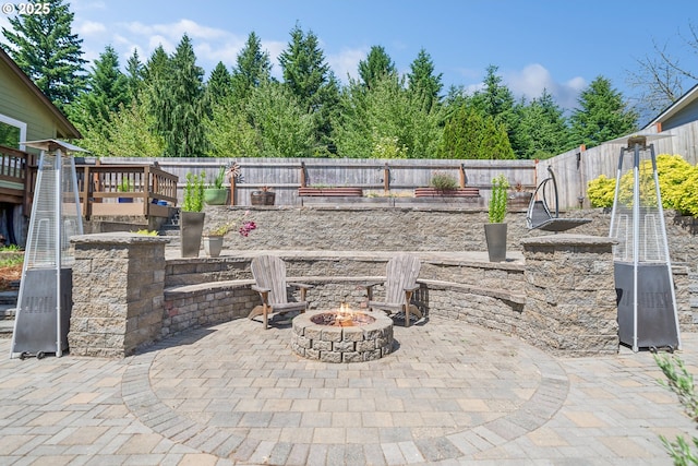 17476 SW Edy Rd, Sherwood, OR 97140 - fenced backyard featuring an outdoor fire pit, a patio, a wooden deck, and a garden