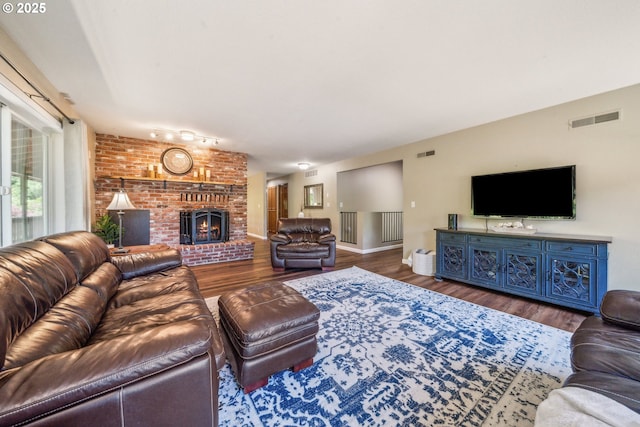 17476 SW Edy Rd, Sherwood, OR 97140 - living area featuring wood finished floors, a brick fireplace, and baseboards