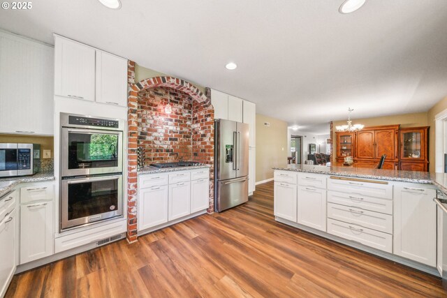 17476 SW Edy Rd, Sherwood, OR 97140 - kitchen with appliances with stainless steel finishes, wood finished floors, white cabinets, and recessed lighting