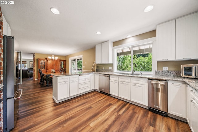 17476 SW Edy Rd, Sherwood, OR 97140 - kitchen featuring appliances with stainless steel finishes, a sink, a peninsula, white cabinetry, and recessed lighting