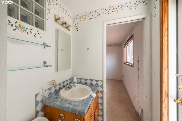 half bath featuring vanity and concrete floors