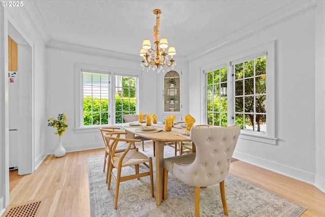 7311 SE 31st Ave, Portland, OR 97202 - dining room with ornamental molding, a chandelier, and light wood finished floors