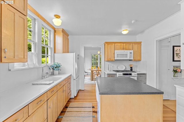 7311 SE 31st Ave, Portland, OR 97202 - kitchen with white appliances, light wood finished floors, light brown cabinets, and a kitchen island