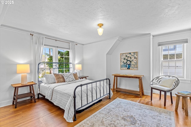 7311 SE 31st Ave, Portland, OR 97202 - bedroom with a textured ceiling, wood finished floors, and ornamental molding