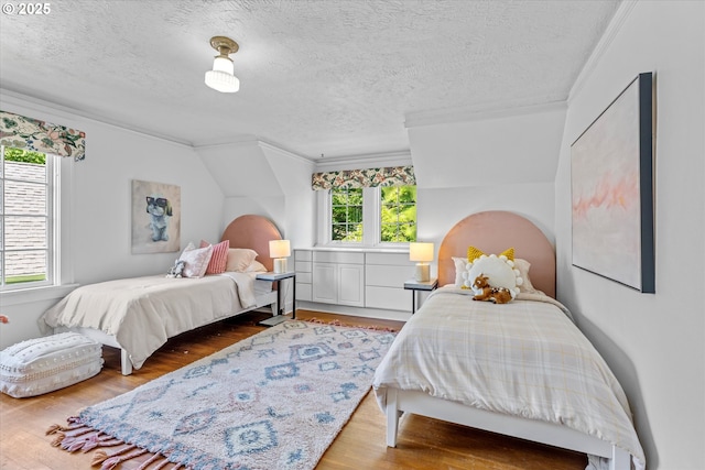 7311 SE 31st Ave, Portland, OR 97202 - bedroom with ornamental molding, wood finished floors, and a textured ceiling
