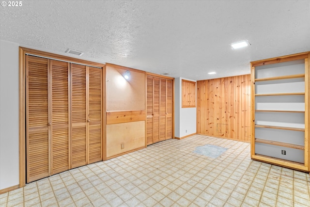 7311 SE 31st Ave, Portland, OR 97202 - unfurnished bedroom featuring light flooring, a textured ceiling, wood walls, and a closet