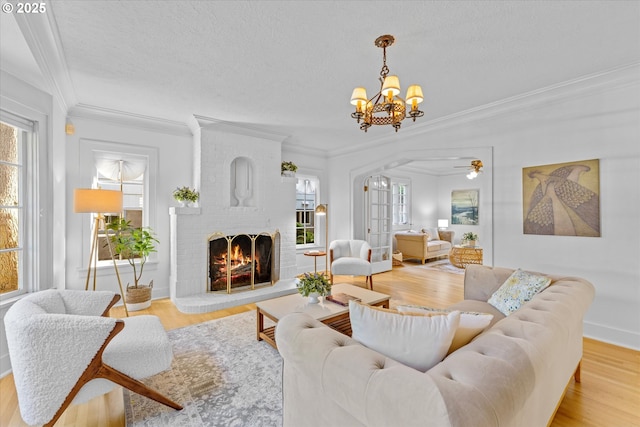 7311 SE 31st Ave, Portland, OR 97202 - living room with a chandelier, healthy amount of natural light, light wood-style floors, crown molding, and a textured ceiling