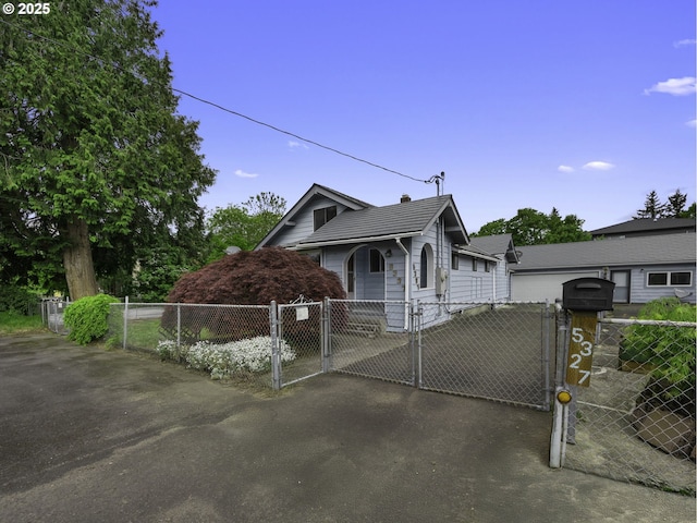 5327 SE Ogden St, Portland, OR 97206 - view of front of house featuring fence private yard, a gate, and aphalt driveway