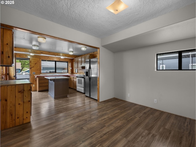 5327 SE Ogden St, Portland, OR 97206 - kitchen featuring a kitchen island, range with electric cooktop, a textured ceiling, stainless steel fridge with ice dispenser, and dark wood-type flooring