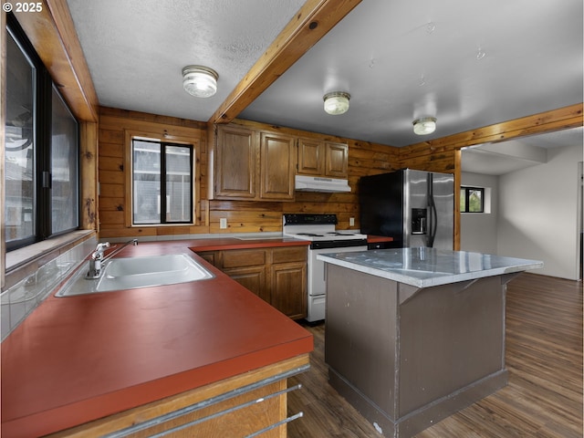 5327 SE Ogden St, Portland, OR 97206 - kitchen featuring a kitchen island, dark wood-style flooring, white range with electric cooktop, a sink, and stainless steel fridge with ice dispenser
