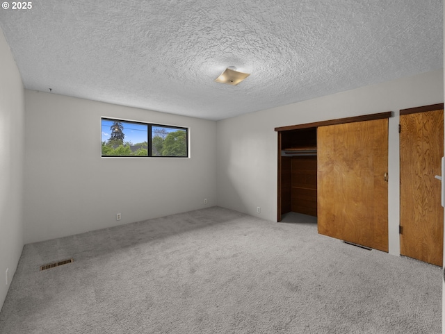 5327 SE Ogden St, Portland, OR 97206 - unfurnished bedroom with carpet, a textured ceiling, and visible vents