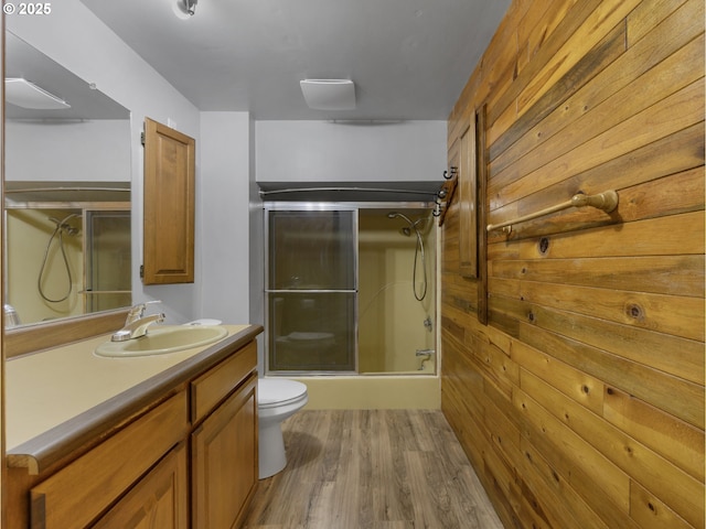 5327 SE Ogden St, Portland, OR 97206 - full bath featuring wooden walls, vanity, toilet, wood finished floors, and a shower with door