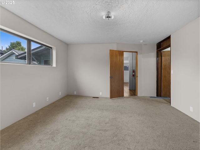 5327 SE Ogden St, Portland, OR 97206 - unfurnished bedroom featuring carpet floors and a textured ceiling