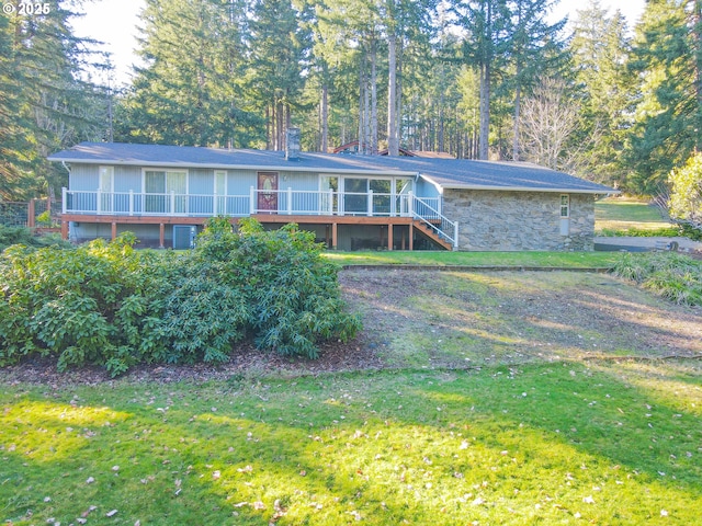 view of front of property featuring a front yard and a deck