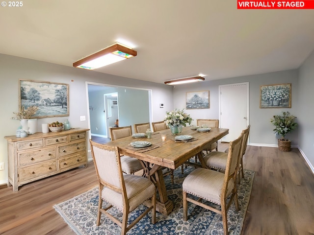 dining space featuring wood-type flooring