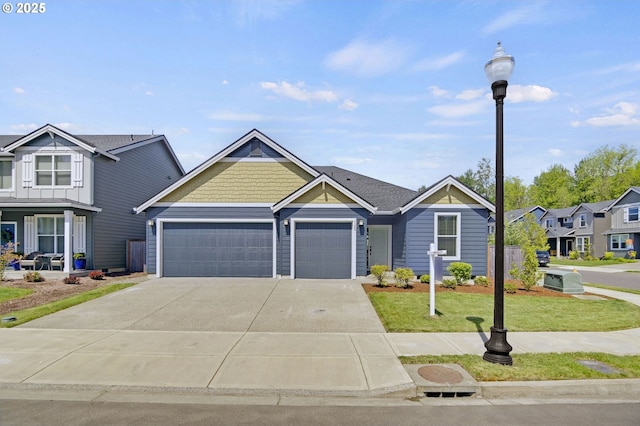 view of front of house featuring a garage, driveway, a front lawn, and a residential view