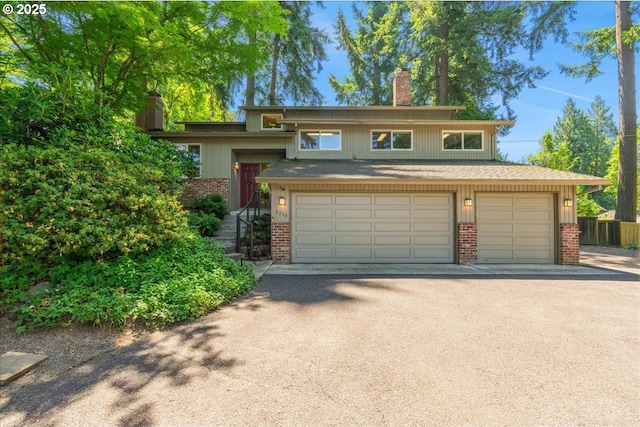 2308 Summit Dr, Lake Oswego, OR 97034 - view of front of home with a chimney, brick siding, an attached garage, and driveway