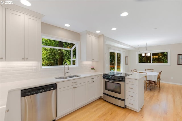 2308 Summit Dr, Lake Oswego, OR 97034 - kitchen with stainless steel appliances, backsplash, light wood-type flooring, light countertops, and recessed lighting