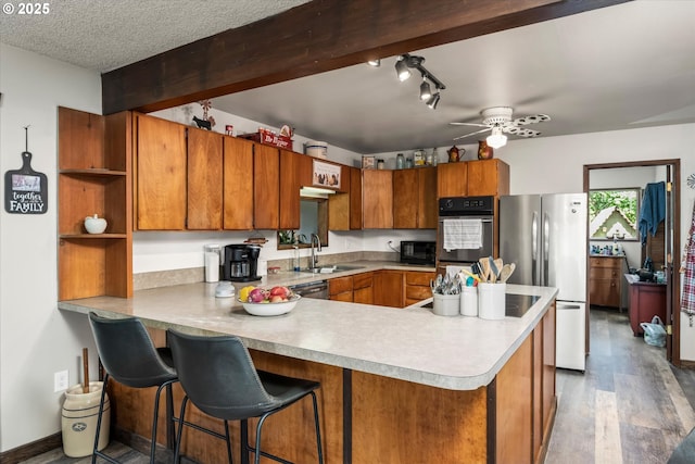 7896 State Highway 38, Drain, OR 97435 - kitchen featuring appliances with stainless steel finishes, open shelves, a peninsula, brown cabinetry, and a ceiling fan