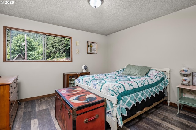 7896 State Highway 38, Drain, OR 97435 - bedroom with dark wood-style flooring and a textured ceiling