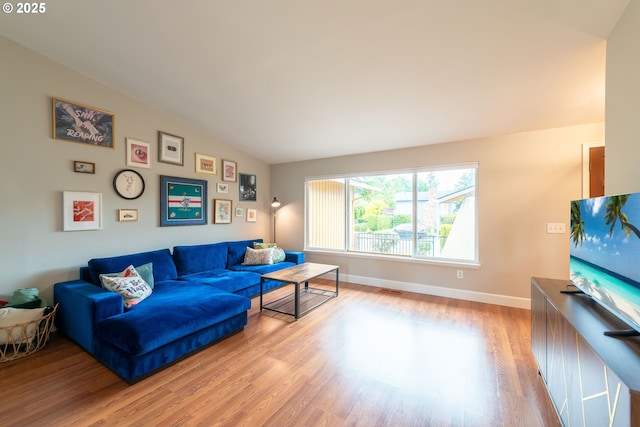 1919 SE 22nd Pl, Renton, WA 98055 - living room featuring vaulted ceiling, wood finished floors, and baseboards