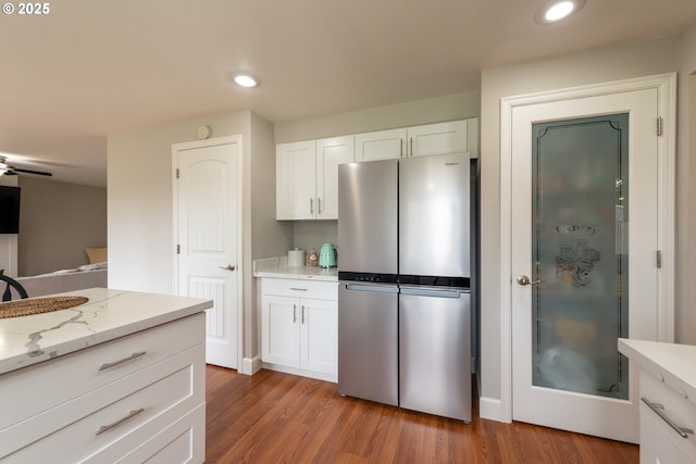 1919 SE 22nd Pl, Renton, WA 98055 - kitchen featuring freestanding refrigerator, white cabinets, light wood finished floors, recessed lighting, and light stone counters