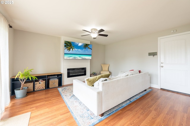 1919 SE 22nd Pl, Renton, WA 98055 - living room featuring a fireplace, light wood-type flooring, and a ceiling fan