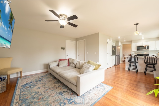 1919 SE 22nd Pl, Renton, WA 98055 - living area with light wood finished floors, ceiling fan, and baseboards
