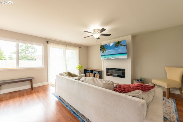 1919 SE 22nd Pl, Renton, WA 98055 - living room with a glass covered fireplace, healthy amount of natural light, light wood-style flooring, and ceiling fan