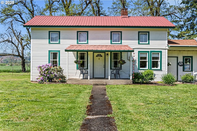 81052 Davisson Rd, Creswell, OR 97426 - view of front facade featuring a porch, a chimney, metal roof, and a front yard