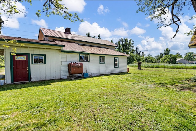 81052 Davisson Rd, Creswell, OR 97426 - back of house with a lawn, board and batten siding, heating fuel, and a chimney