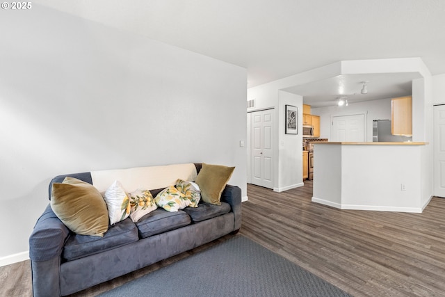 living room with wood finished floors and baseboards