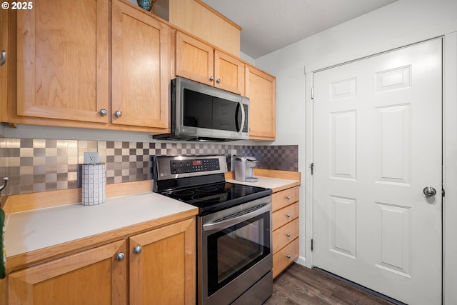 kitchen featuring appliances with stainless steel finishes, light countertops, light brown cabinets, tasteful backsplash, and dark wood finished floors