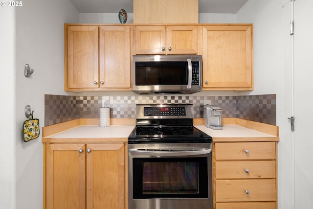 kitchen featuring stainless steel appliances, light brown cabinetry, light countertops, and tasteful backsplash