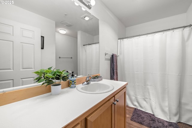 full bathroom with vanity and wood finished floors