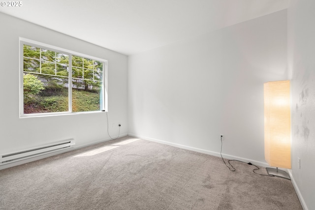 unfurnished room featuring carpet floors, a baseboard heating unit, and baseboards