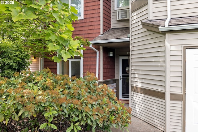 entrance to property with roof with shingles