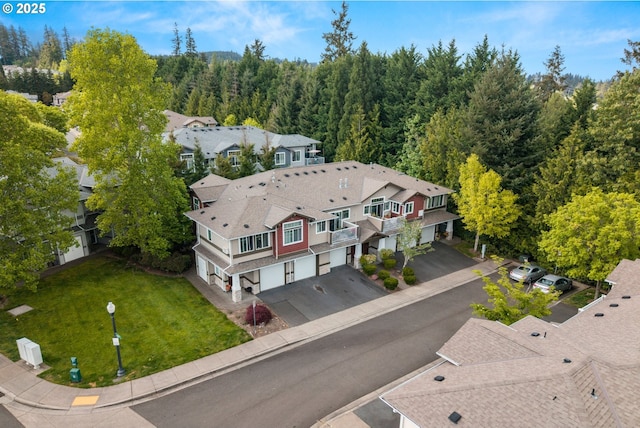 aerial view of property and surrounding area with a forest