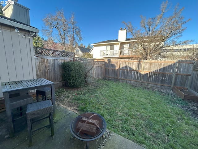 view of yard featuring a fire pit and a patio