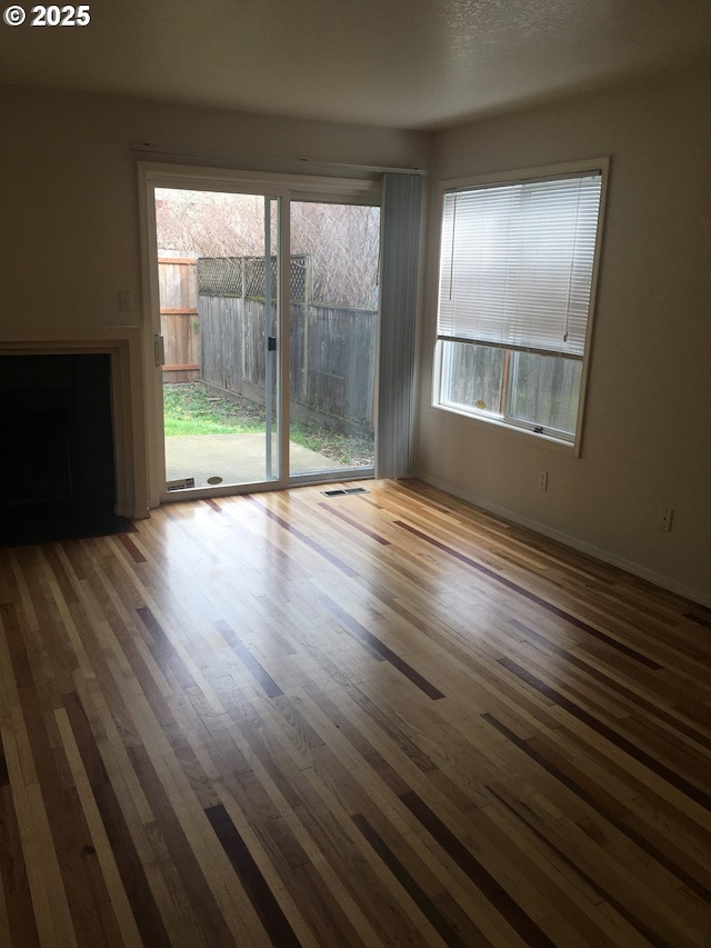 unfurnished room with hardwood / wood-style flooring