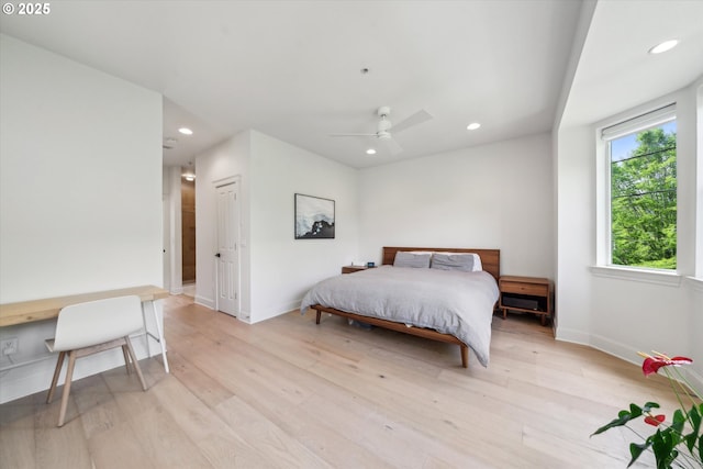 bedroom with baseboards, recessed lighting, and light wood-style flooring