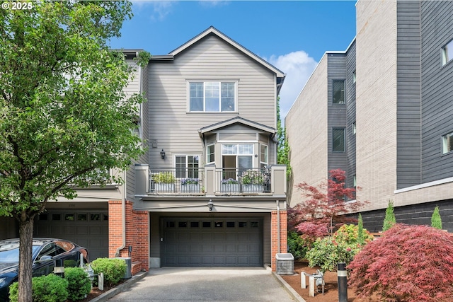 view of front of home featuring a garage, aphalt driveway, brick siding, and a balcony